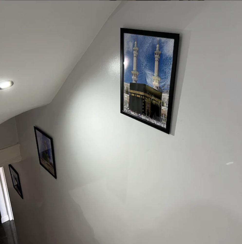 Customer photo: Kaaba print in a black frame on a stairway wall